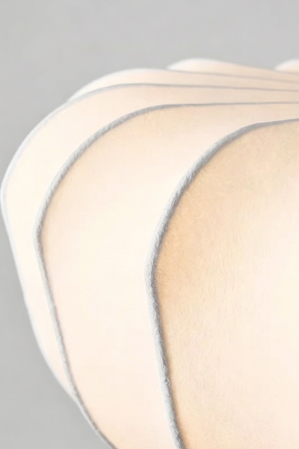 Close-up of the silhouette details of the Baird Mid-Century Silk Pendant Light showcasing its elegant silk shade.