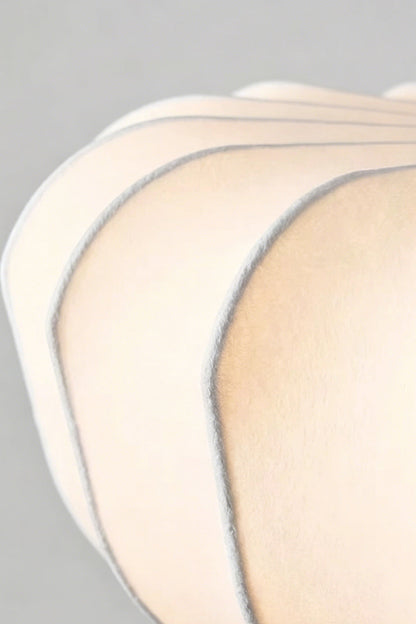 Close-up of the silhouette details of the Baird Mid-Century Silk Pendant Light showcasing its elegant silk shade.