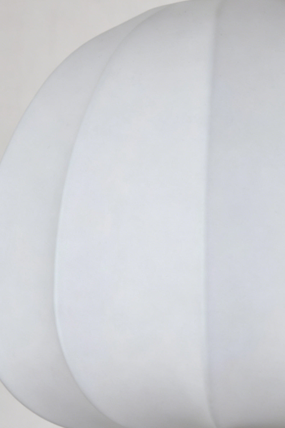 Baird Mid Century Pumpkin Wall Lamp | Metal, Fabric, Wood | Extreme close-up view highlighting the smooth white fabric texture and curved piping of the unlit shade | Detail shot | vexa lamps