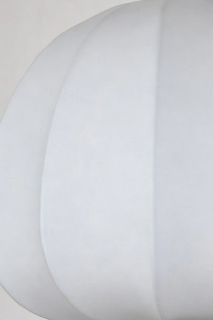 Baird Mid Century Pumpkin Wall Lamp | Metal, Fabric, Wood | Extreme close-up view highlighting the smooth white fabric texture and curved piping of the unlit shade | Detail shot | vexa lamps