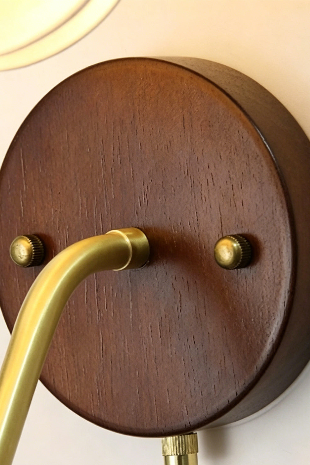 Baird Mid Century Pumpkin Wall Lamp | Metal, Fabric, Wood | Close-up detail of the circular dark wood wall canopy and brass connecting hardware | Detail shot | vexa lamps