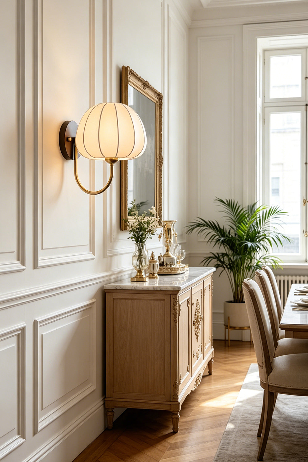 Baird Mid Century Pumpkin Wall Lamp | Metal, Fabric, Wood | Mounted on a paneled wall above a wooden credenza next to a classic dining area | vexa lamps
