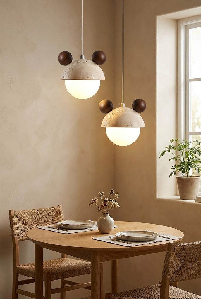 Pair of bear ear travertine pendant lights | Travertine, Metal, Glass | Hanging over a small round wooden dining table | vexa lamps