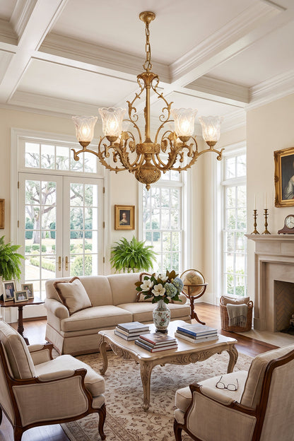 Beatrix Acanthus Leaf Chandelier | Ornate Brass and Frosted Carved Glass | Hanging in a classic luxury living room with coffered ceilings, elegant cream sofas, and a fireplace | vexa lamps