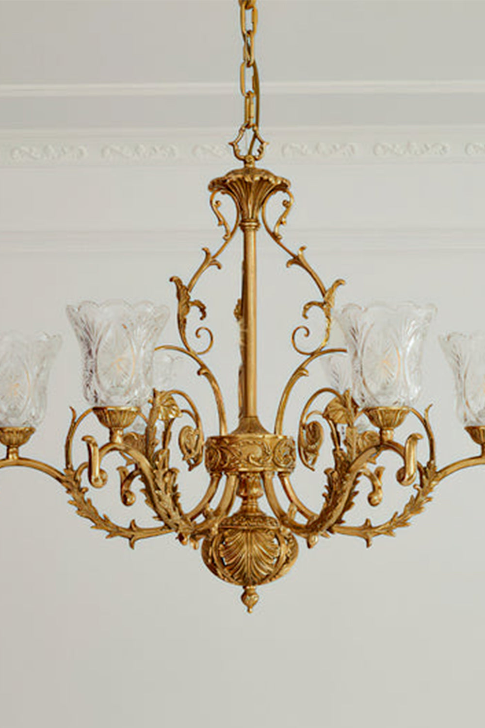Beatrix Acanthus Leaf Chandelier | Ornate Brass and Frosted Carved Glass | Standard unlit product view hanging from a plain plaster ceiling against a light grey background | vexa lamps