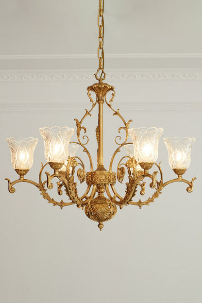 Beatrix Acanthus Leaf Chandelier | Ornate Brass and Frosted Carved Glass | Full studio presentation of the classic French-style brass fixture glowing warmly against a light wall | vexa lamps