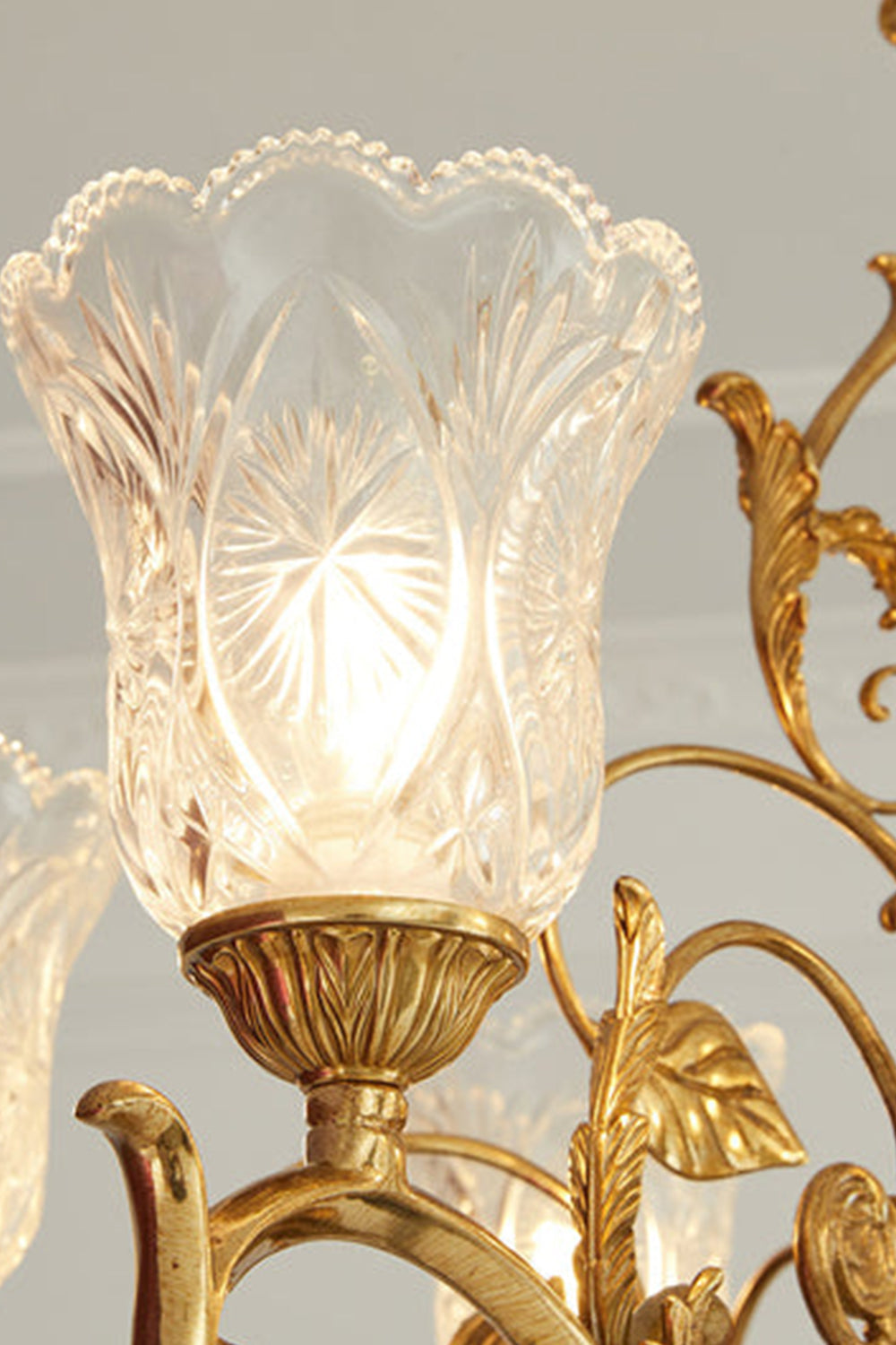 Beatrix Acanthus Leaf Chandelier | Ornate Brass and Frosted Carved Glass | Close-up macro detail of the lit ruffled glass shade showcasing the starburst carvings and gold leaf frame | vexa lamps