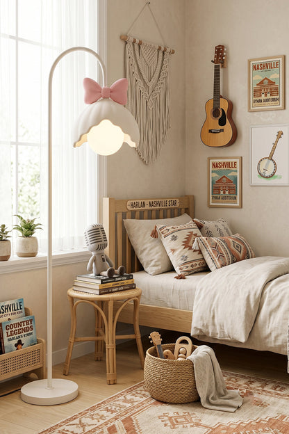Bella Bow Arched Floor Lamp | Metal, Resin | Pink bow version styled as a cozy nursery corner nightlight next to a wooden toddler bed and boho wall decor | vexa lamps