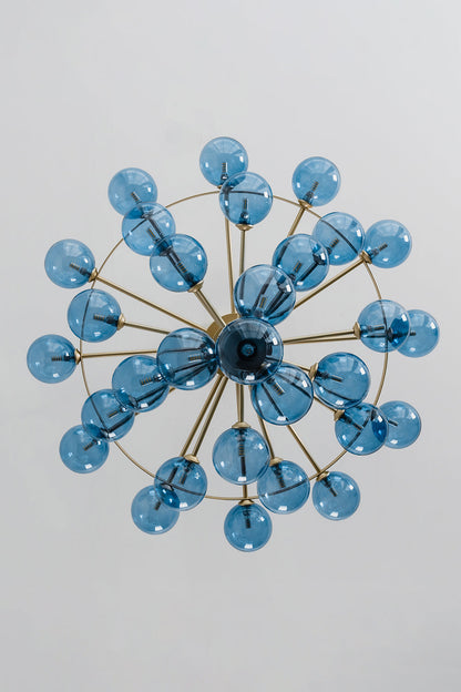 Blue Glass Bubble Globe Tiered Chandelier | Blue Glass and Brass Metal | Directly underneath bottom-up view displaying the radial starburst pattern of the blue spheres | vexa lamps