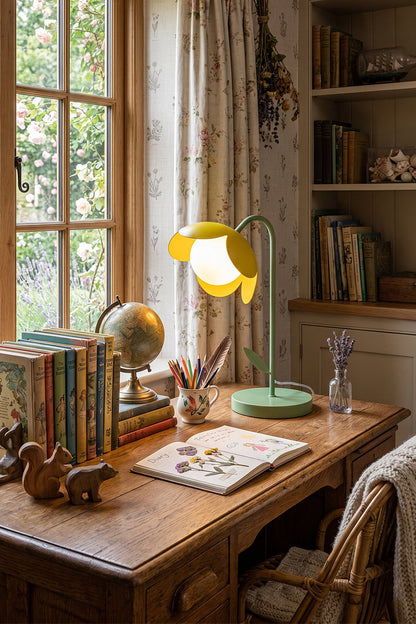 Classic vintage study room desk scene | Metal and glass | Yellow petal botanical lamp on wood desk | Quill pen, classic books, vintage globe | Intricate wood grain | vexa lamps