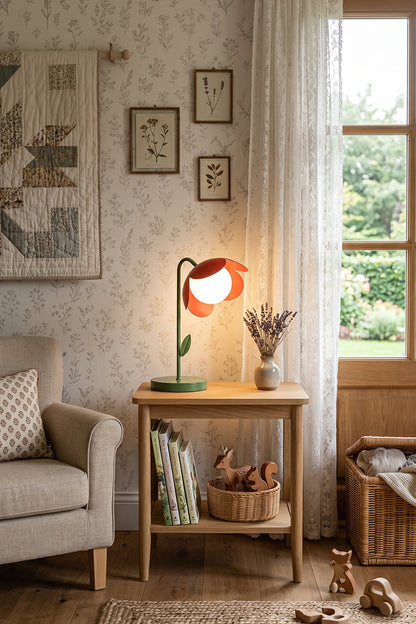 Calm nature-print living area scene | Metal and glass | Red petal botanical lamp on side table | Grey armchair and nature wallpaper | Quiet reading nook | vexa lamps