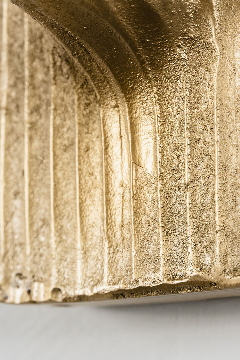 Close-up of the textured surface of the Bryony Torch Alabaster Brass Wall Lamp, showcasing its elegant design.