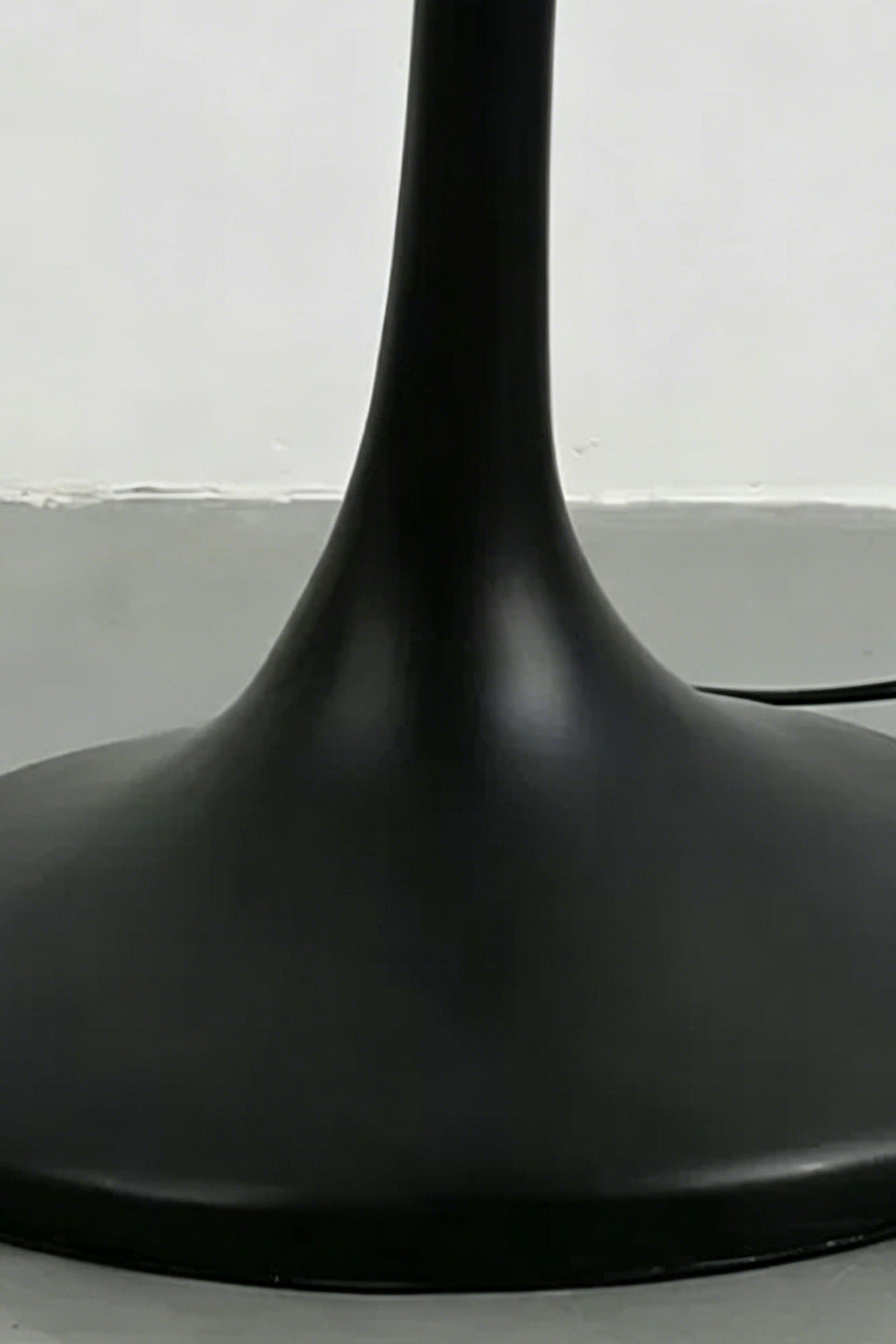 Close-up of the sleek black trumpet-style metal base | Metal