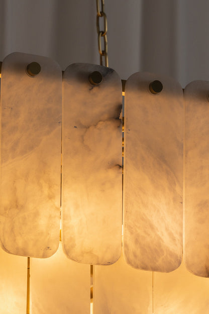 Callista Tiered Alabaster Chandelier | Alabaster, Metal | Detailed close-up view of the illuminated translucent stone tiles highlighting the rich warm light transmission and internal veining | Detail shot | vexa lamps