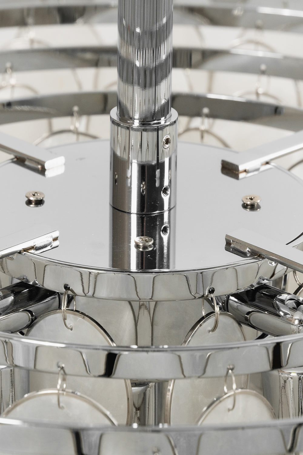 Chrome hardware and tiered frame detail | Iron | Close-up of the polished silver rods and tiers | vexa lamps