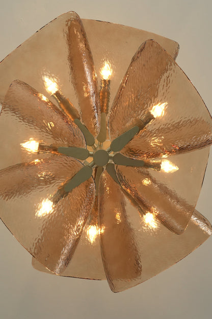 Lit Cardiff Textured Wave Chandelier from below | Metal, Glass | Showing the petal arrangement and warm bulbs | vexa lamps