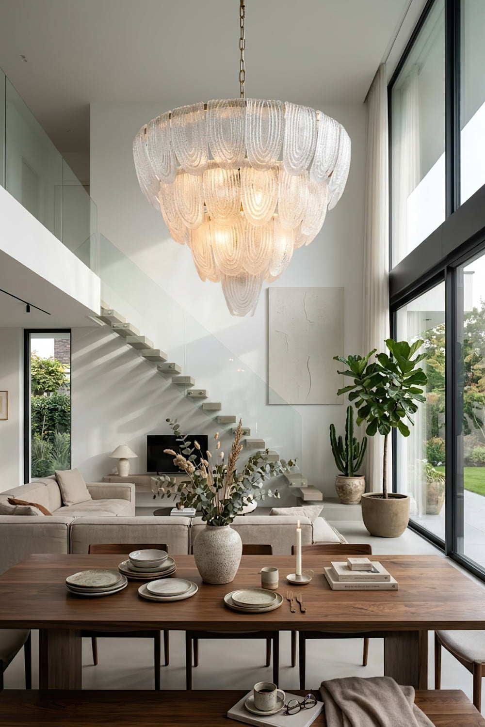 Elegant cascading glass chandelier near staircase | Metal, Glass | High-ceiling living room interior with modern decor | vexa lamps