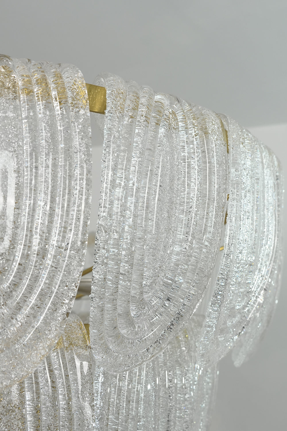 Detailed close-up of textured glass petals | Glass | Showing the intricate organic pattern of the cascading chandelier | vexa lamps