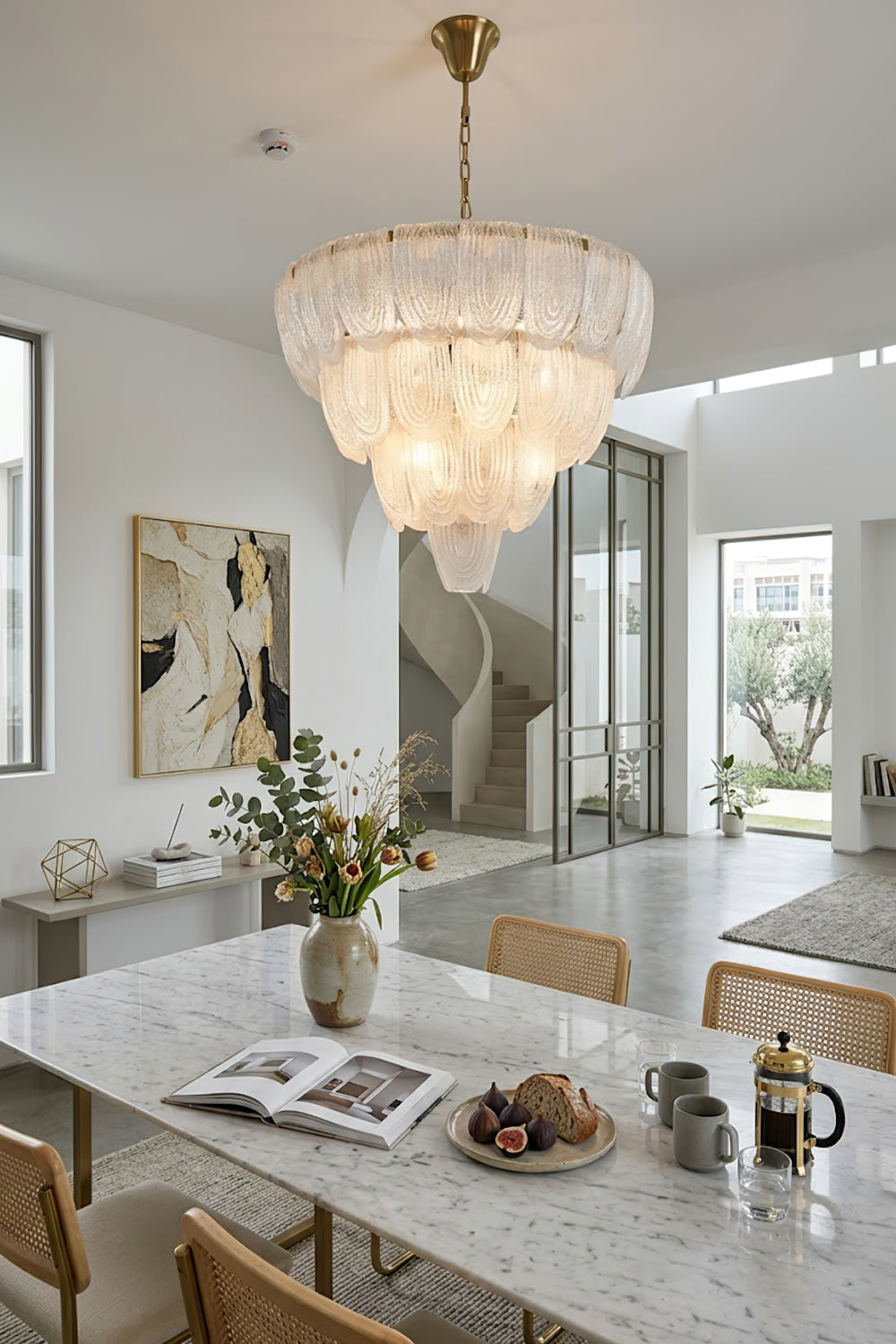 Elegant glass petal chandelier over dining table | Metal, Glass | Installed in a bright modern dining room with marble table | vexa lamps