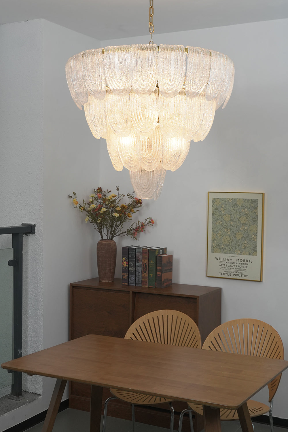 Large cascading glass chandelier over dining table | Metal, Glass | Centered in a traditional dining room with wooden chairs | vexa lamps