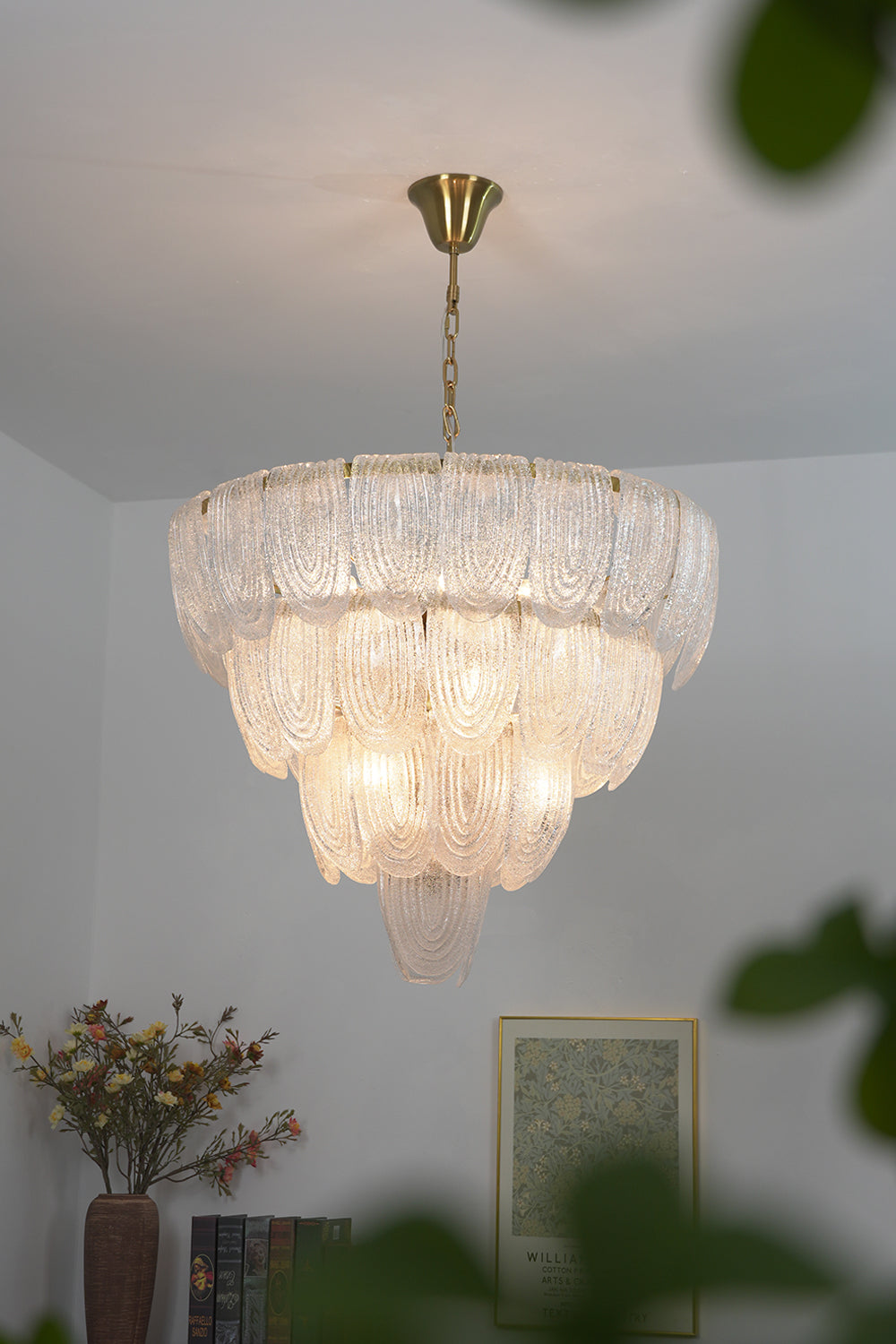 Cascading glass petal chandelier in modern living room | Metal, Glass | View from a distance showing high ceilings and natural light | vexa lamps