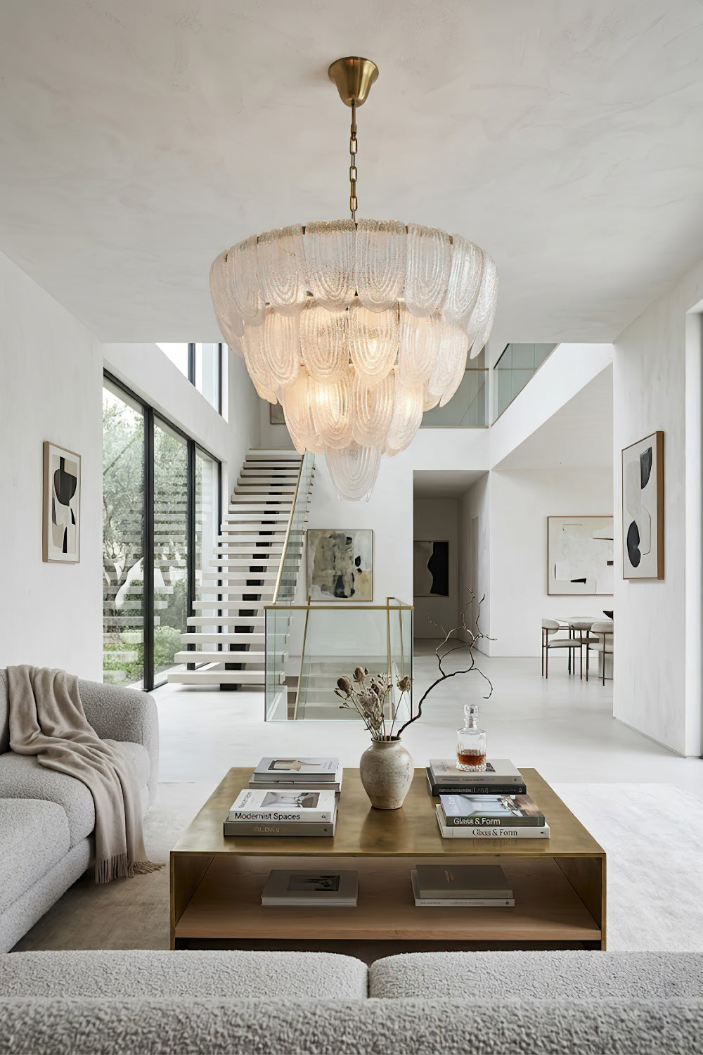 Luxurious glass petal chandelier in open-plan home | Metal, Glass | Centered over a coffee table in a bright modern living area | vexa lamps