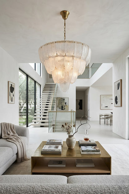 Luxurious glass petal chandelier in open-plan home | Metal, Glass | Centered over a coffee table in a bright modern living area | vexa lamps