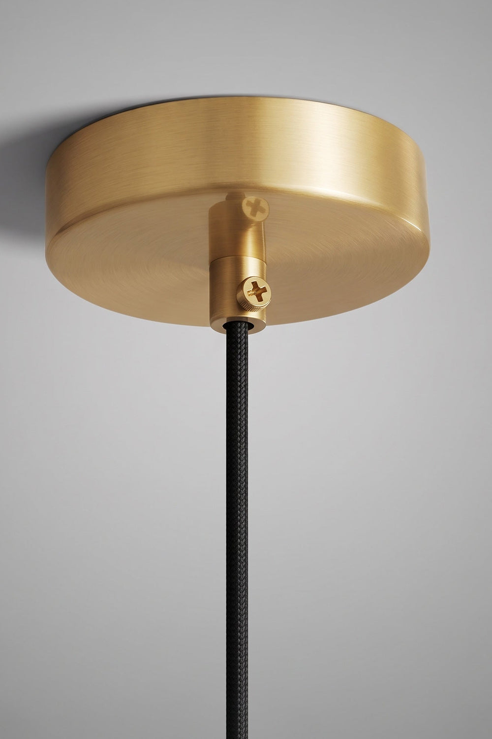 Caspian Conical Alabaster Pendant Light | Natural Alabaster and Brass | Close-up macro shot focusing on the round polished gold metal ceiling canopy and black cord | vexa lamps