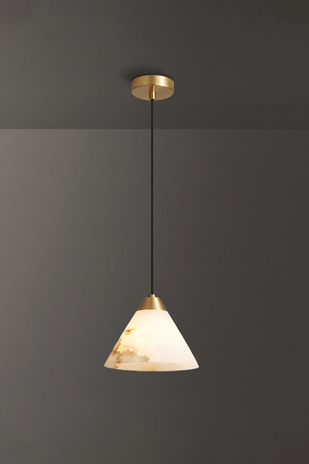 Caspian Conical Alabaster Pendant Light | Natural Alabaster and Brass | Single product view hanging fully lit with gold hardware options against a solid dark grey background | vexa lamps