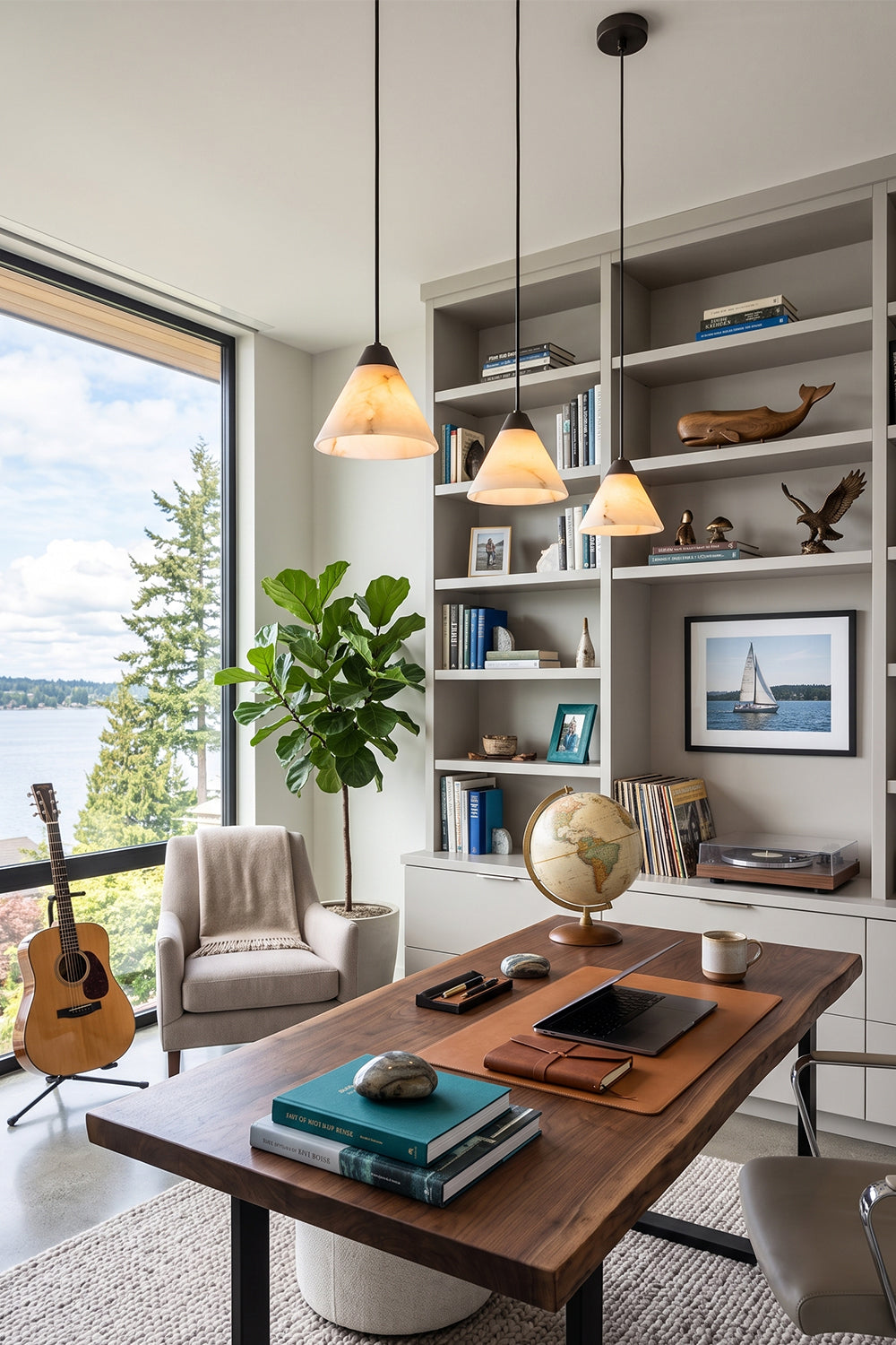 Caspian Conical Alabaster Pendant Light | Natural Alabaster and Brass | Hanging over a wooden study desk in a cozy home library room with a guitar on the wall | vexa lamps