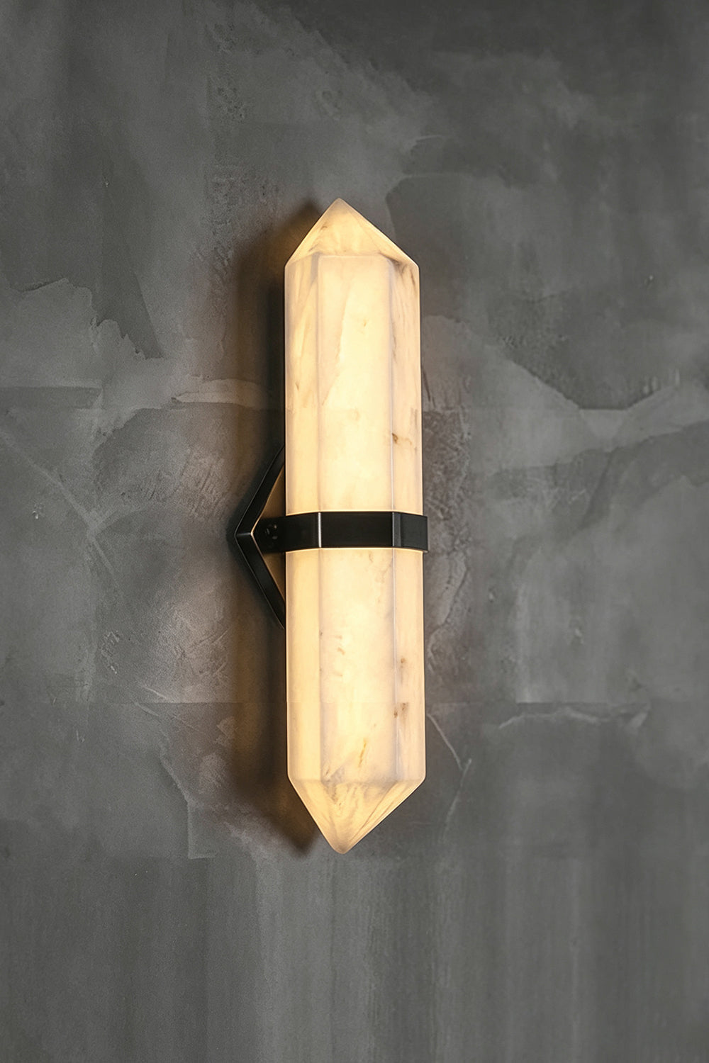 Cassian Faceted Alabaster Wall Sconce featuring a faceted alabaster column and brass-toned bracket on a wall.