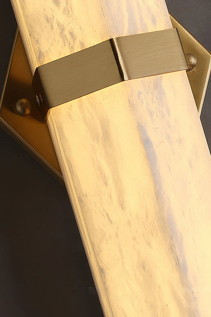 Close-up of the Cassian Faceted Alabaster Wall Sconce showcasing the brass-toned bracket and natural alabaster column.