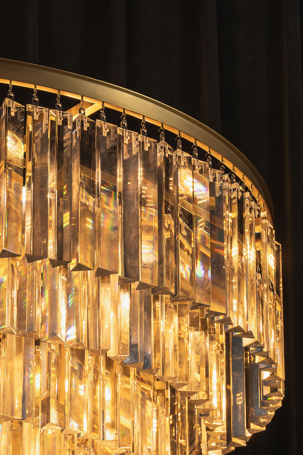 Cassian Tiered Prism Ring Chandelier | Clear Prism Glass and Brass | Close-up view of the brass ring and warm glowing glass prisms | vexa lamps