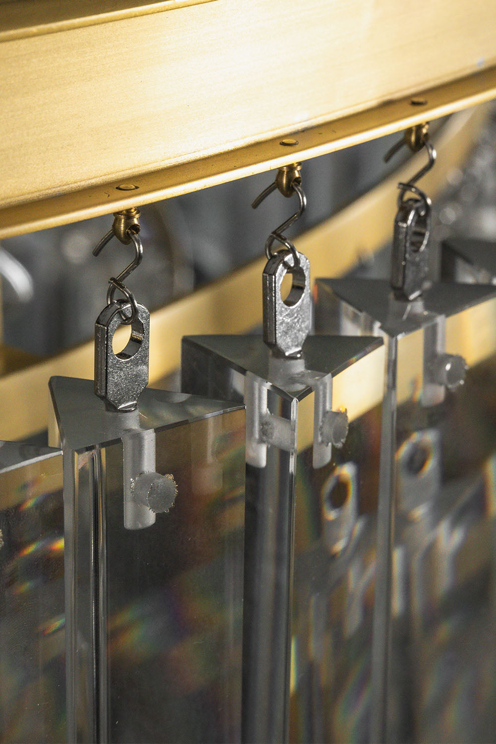 Cassian Tiered Prism Ring Chandelier | Clear Prism Glass and Brass | Close-up of the metal hooks attaching clear prisms to the frame | vexa lamps