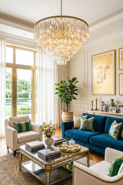 Cassian Tiered Prism Ring Chandelier | Clear Prism Glass and Brass | Hanging in a bright living room with a blue velvet sofa | vexa lamps