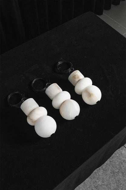 Celestial Alabaster pendants | Alabaster, Metal | Trio of unlit stone shades on dark surface | vexa lamps