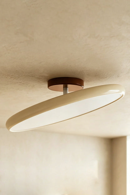 Celestial Disc Lacquered Ceiling Light | Acrylic, Metal | Angled side-profile view of the unlit green-trimmed light on a grey wall, showing depth | Detail shot | vexa lampsCelestial Disc