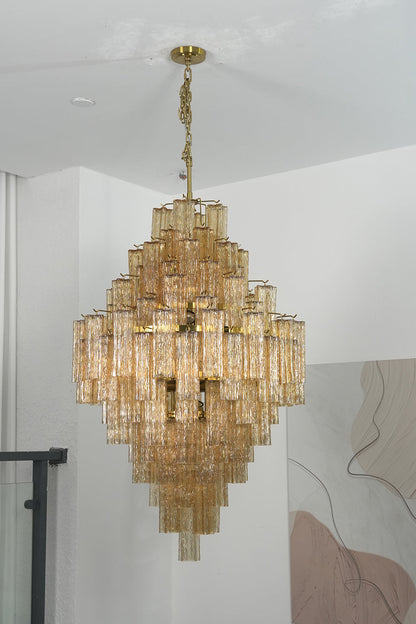 Celestial Glass Cascade Chandelier elegantly illuminated in a modern interior, showcasing its fluted glass design.