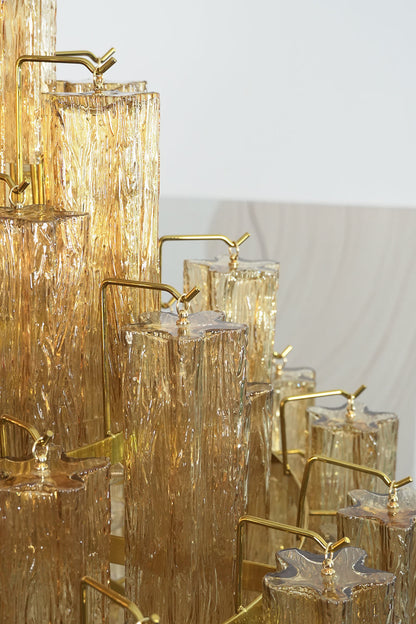 Celestial Glass Cascade Chandelier showcasing shimmering fluted glass tubes and gold accents in a grand design.