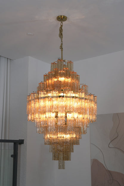 Celestial Glass Cascade Chandelier featuring multi-tiered fluted glass tubes and warm illuminated glow.
