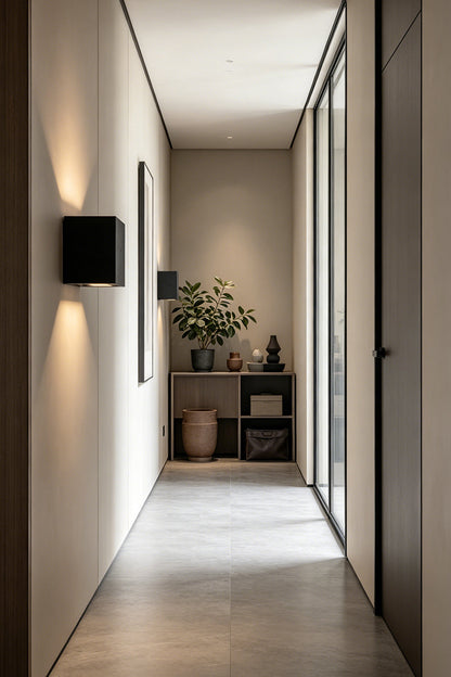 Celestial Tectonic Black Travertine Wall Lamp | Black Travertine | Wall installation in a long minimalist hallway | vexa lamps