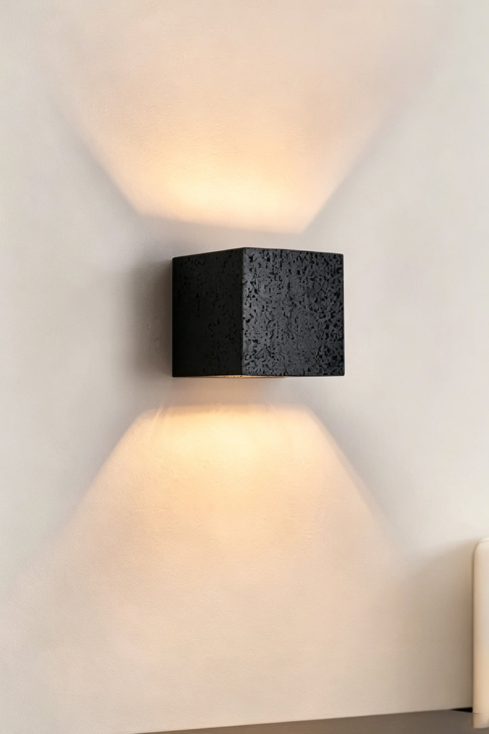 Celestial Tectonic Black Travertine Wall Lamp | Black Travertine | Frontal view emphasizing dramatic up-down light distribution | vexa lamps