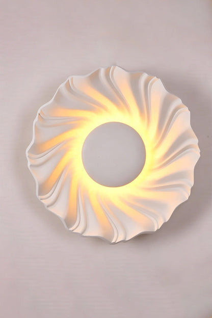 Centripetal Solstice Metal Wall Lamp | Metal, Resin | White textured lamp on a plain background, providing warm light | Isolated lit variant shot | vexa lamps