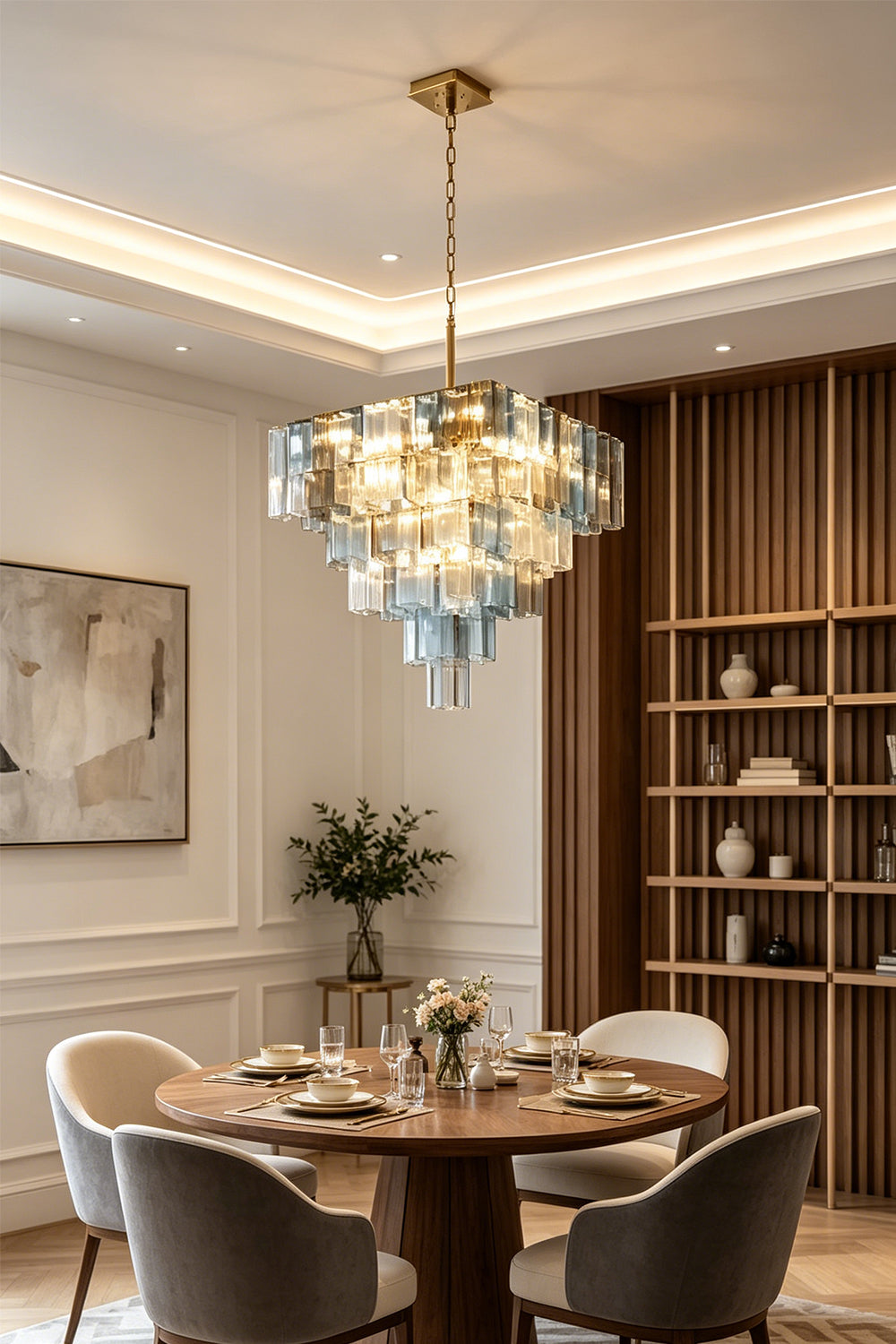 Clarissa Tiered Square Glass Chandelier | Dining Room Chandelier | Hanging elegantly as a centerpiece over a round wooden dining table and contemporary chairs in a luxury dining space | vexa lamps