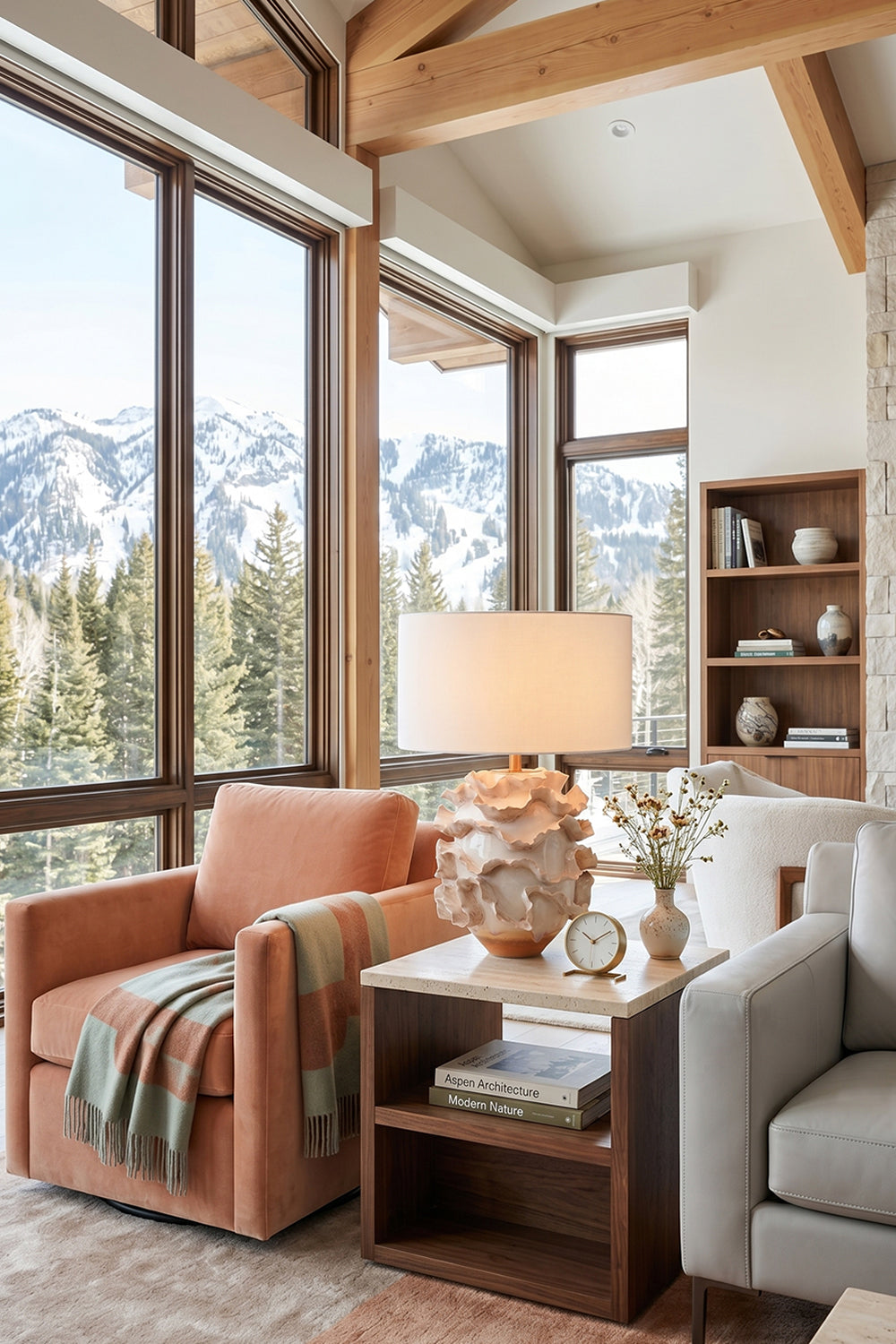 Coralia Ruffled Ceramic Table Lamp in a cozy living room with mountain view and warm decor elements.
