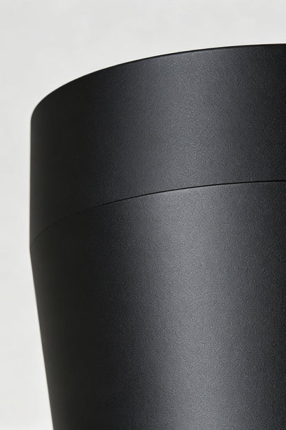Close-up of the sleek black finish of the Corin Low-Profile Ceiling Fan Light, highlighting its modern design.