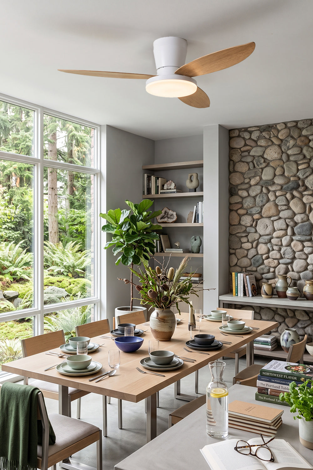 Corin Low-Profile Ceiling Fan Light illuminating a modern dining space with wooden blades and stylish decor.