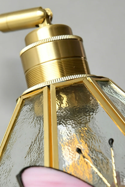 Cynthia Butterfly Articulated Wall Lamp | Stained Glass, Metal, Wood | Detailed close-up showing the polished gold brass socket cap connection sitting atop the clear textured hammered glass shade | Detail shot | vexa lamps