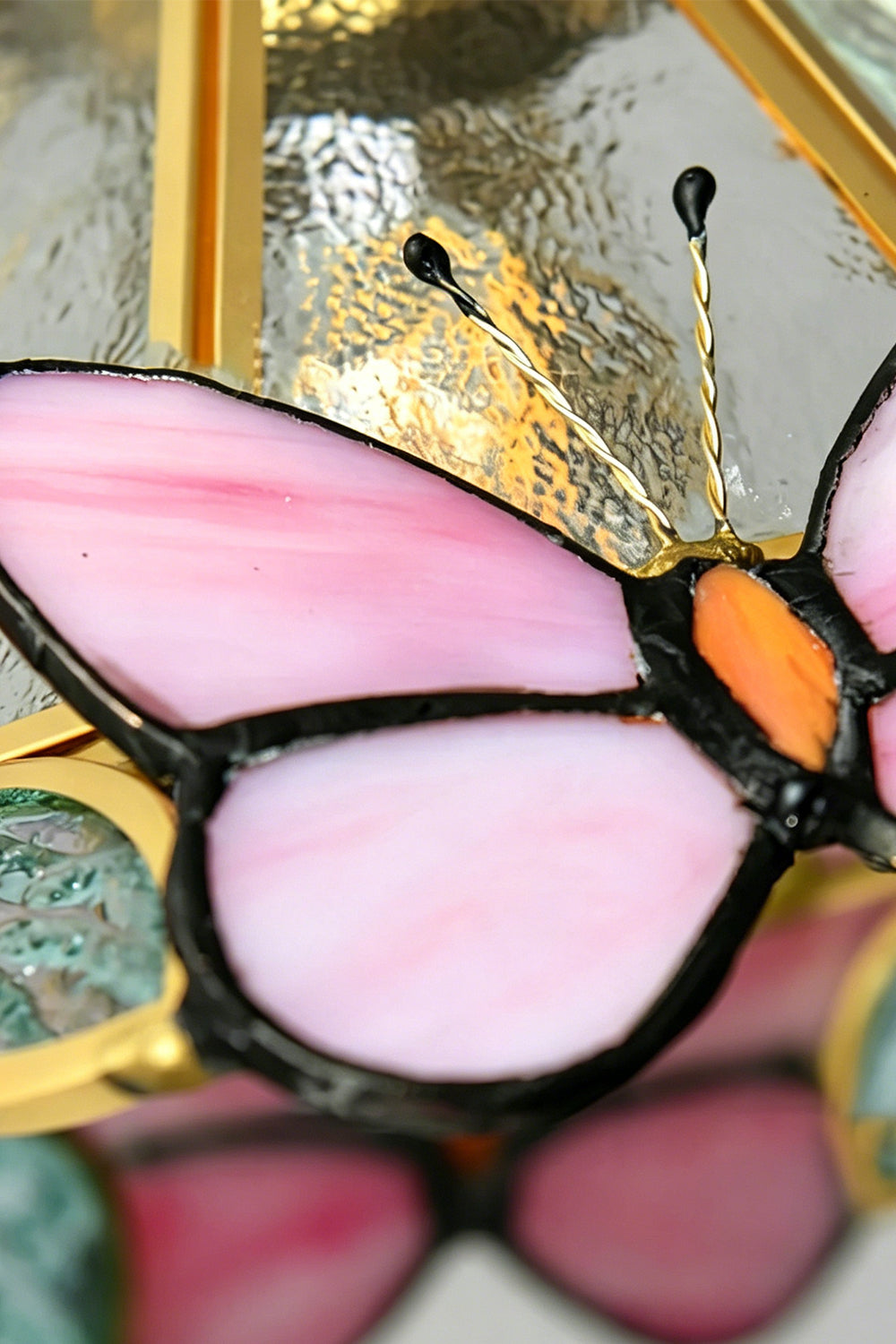 Cynthia Butterfly Articulated Wall Lamp | Stained Glass, Metal, Wood | Macro close-up focus on a pink stained glass butterfly wing section with clean solder lines and delicate wire antennas | Detail shot | vexa lamps
