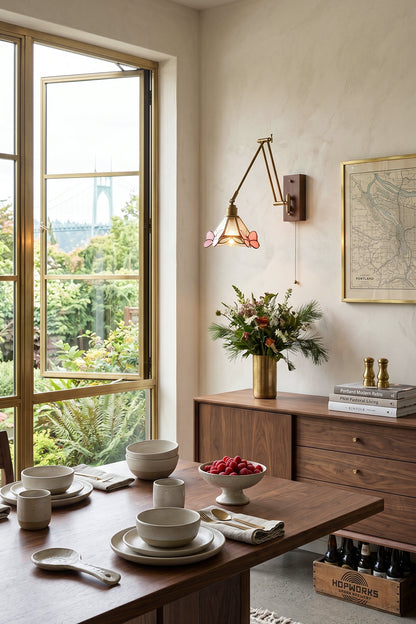 Cynthia Butterfly Articulated Wall Lamp | Stained Glass, Metal, Wood | Wall-mounted in a sunlit dining area next to a wooden dining table and large open glass doors overlooking a lush garden | vexa lamps